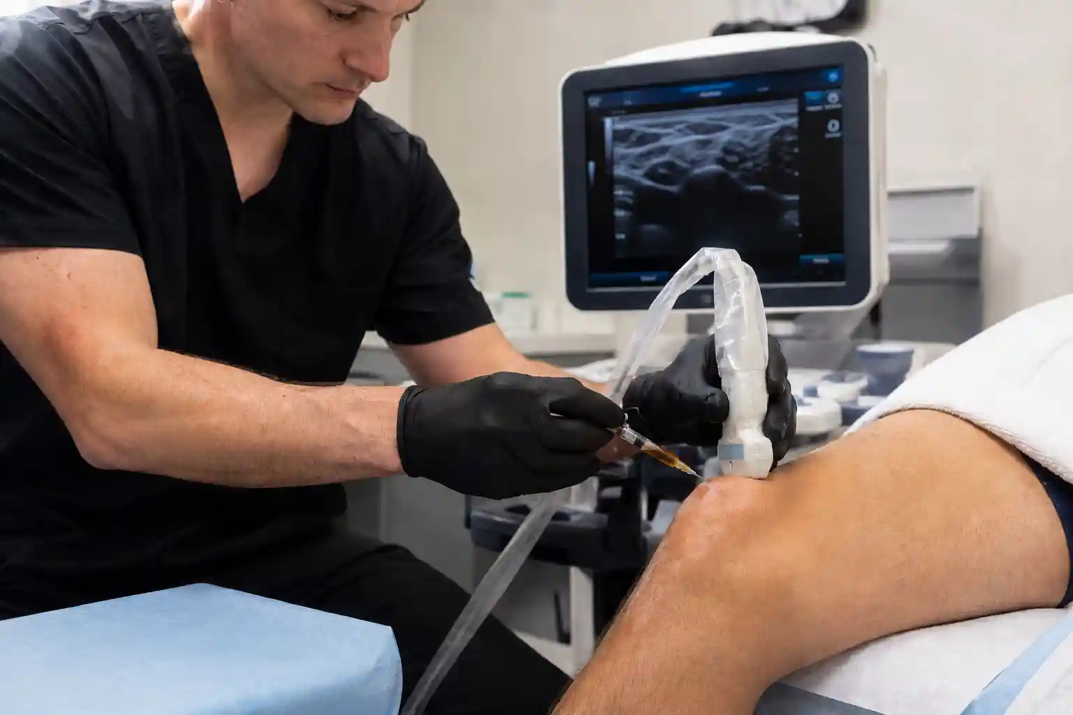 Clinician performing PRP injection procedure using ultrasound guidance in a regenerative medicine treatment setting